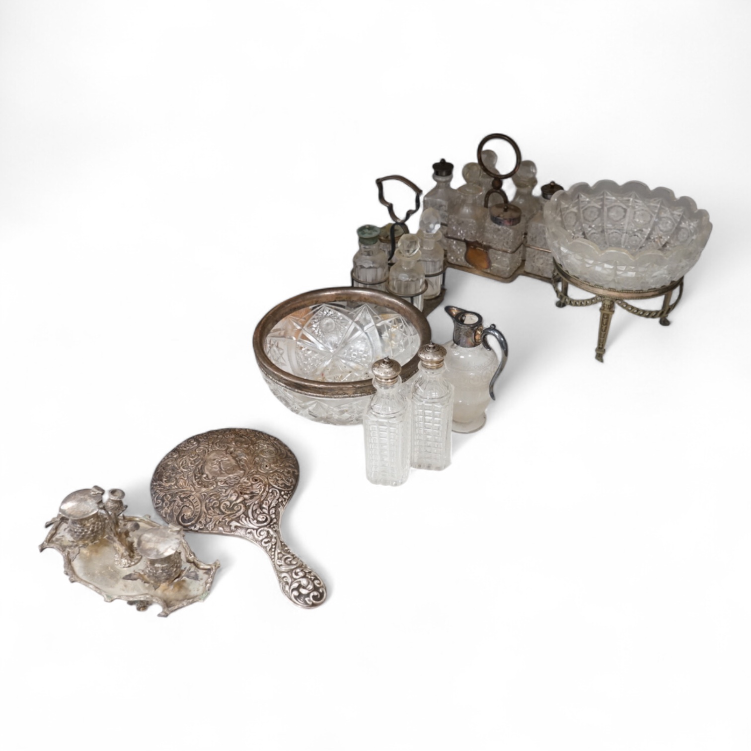 A collection of silver plated ware, and an embossed silver hand-mirror, largest 21cm in diameter